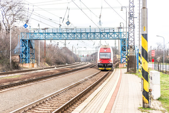Red train under blue bridge