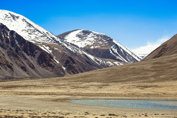 Fototapeta na wymiar The valley at the foot of the mountains on Pamir. Spring. Tajiki