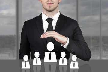 businessman holding protective hand above employee staff