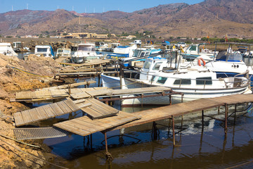 Fototapeta na wymiar Small fishing boats on the old pier