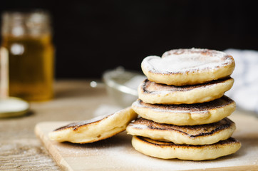Pancake hot sprinkled with powdered sugar on white plate