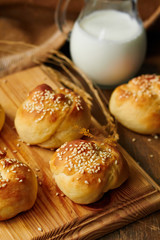 Homemade bread rolls with sesame seeds and milk