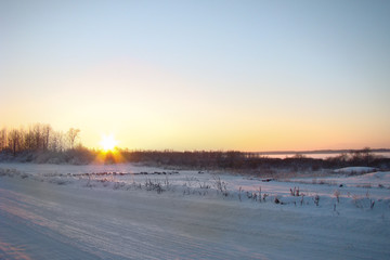 cold winter sunset on the country road