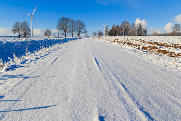 Fototapeta premium Winter landscape road snow covered fields windmills