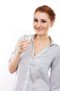 Happy young girl with a glass of water