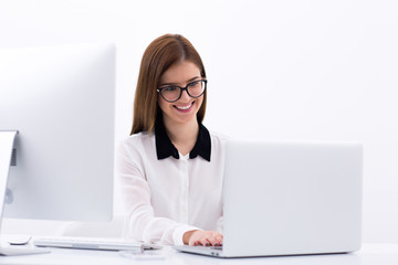 Happy businesswoman working on the laptop at office