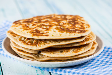 stack of pancakes on rustic wooden table