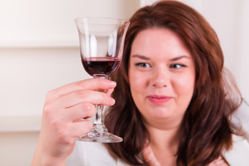 Cheerful woman holding a glass of wine