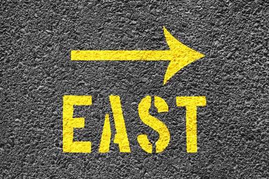 East Arrow Sign On The Asphalt