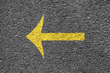 Yellow Arrow Sign On The Asphalt