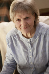 Portrait of thinking senior woman at home top view