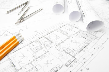 Construction planning drawings rolled on the worktable