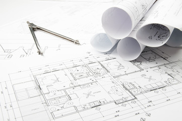 Rolled construction planning drawings on the worktable