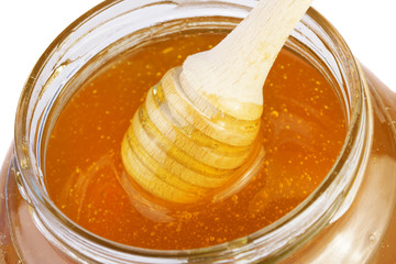 Honey background with wooden dipper