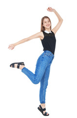 Happy young fashion girl in jeans jumping isolated