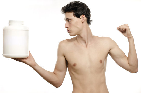 Skinny man training, drinking a protein shake, taking steroids