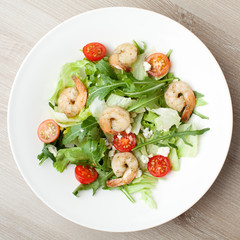 Fresh gourmet seafood salad with shrimps, greens, cherry tomatoe