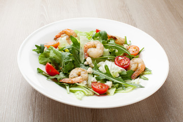 Fresh gourmet seafood salad with shrimps, greens, cherry tomatoe