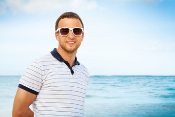  Caucasian man in white sunglasses on sea coast