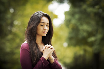 Woman praying outdoors