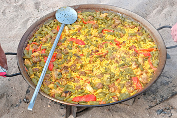 Traditional Spanish paella with human hands