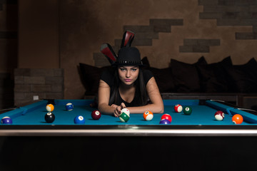 Young Woman Lying On The Billiard Table