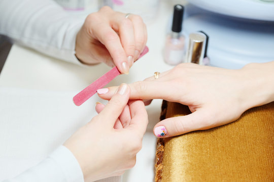 woman doing a manicure at the beauty salon