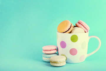 Assortment of gentle colorful macaroons in mug