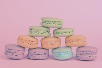 Tasty macaroons on color background