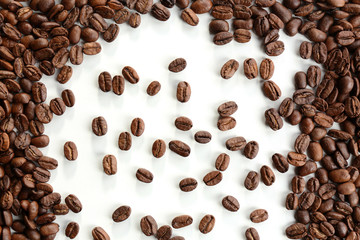 Coffee beans on white table, close-up