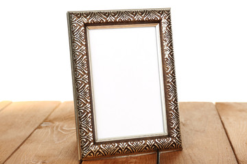 Photo frame on wooden table isolated on white