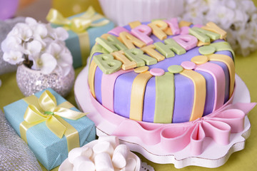 Delicious birthday cake on table close-up