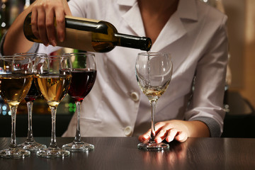 Bartender working at counter on bar background