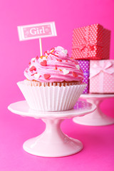 Delicious cupcake with inscription on pink background