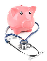 Piggy bank with stethoscope isolated on white