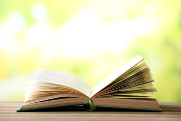 Open book on blurred bright background