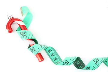 Measuring tape with Christmas decoration isolated on white