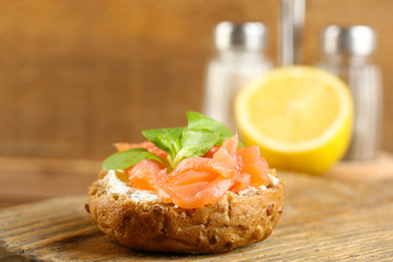 Canape with salmon and herbs on wooden background
