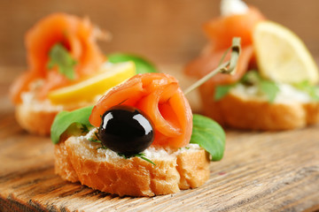 Canapes with salmon, black olive and herbs