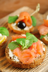 Canapes with salmon, black olive and herbs