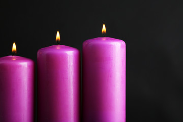 Purple candles on black background