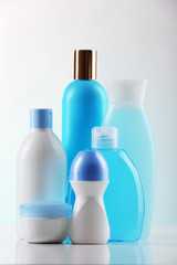Cosmetic bottles on light background