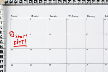 Diet concept - measure tape on calendar, close up