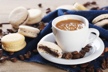 Gentle colorful macaroons and  coffee in mug
