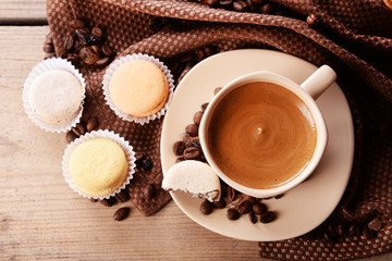 Gentle colorful macaroons and  coffee in mug