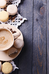 Gentle colorful macaroons and  coffee in mug