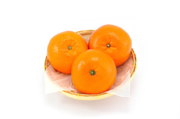 Group of orange fruit on bamboo basket