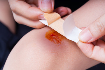 Child knee with a plaster (for wounds) and bruise