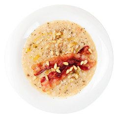 Risotto with bacon and pine nuts, isolated