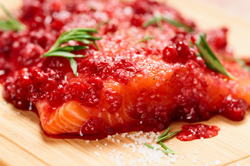 Salmon steak marinated in salt with rosemary and redberries